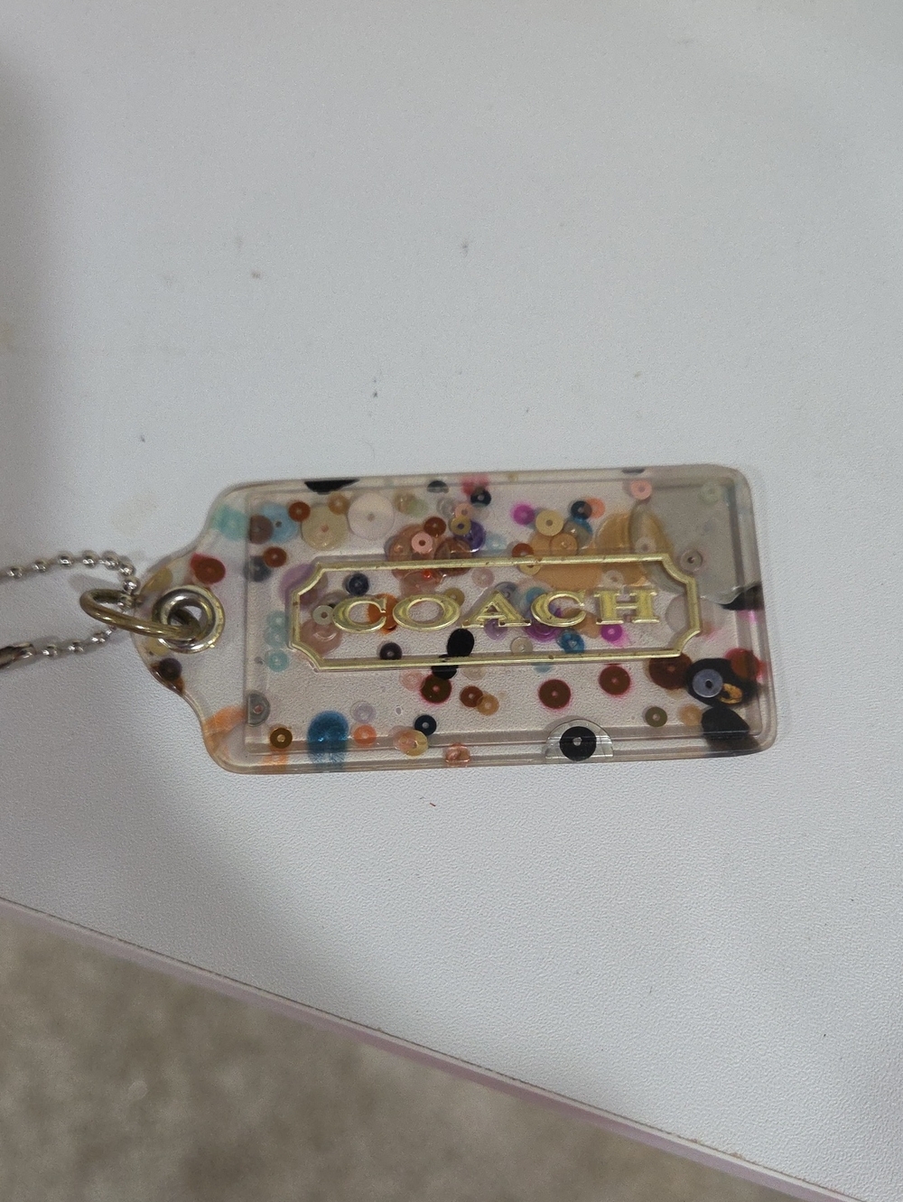 Coach Clear Confetti Acrylic Hang Tag  with Gold Logo